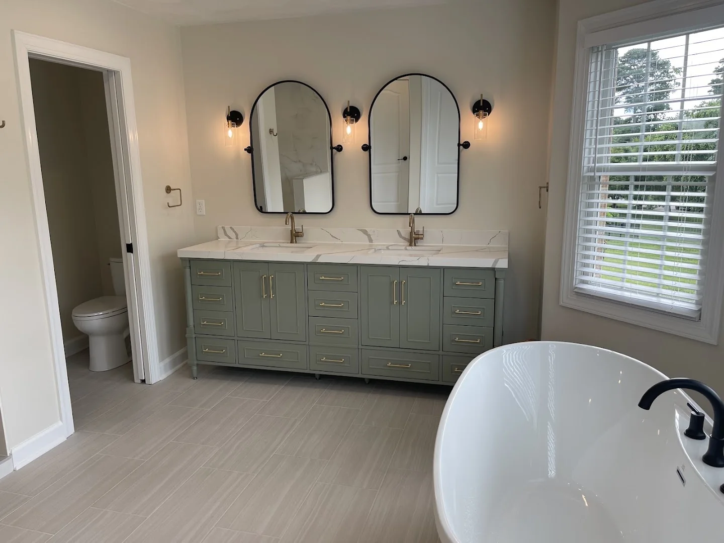 Double vanity with pale green cabinetry